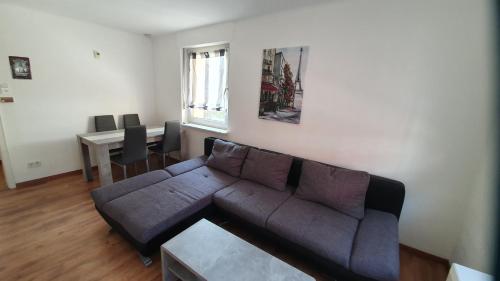 a living room with a couch and a table at Ferienwohnung Biewer in Trier