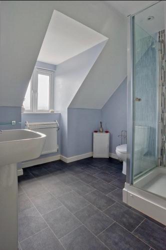 a bathroom with a sink and a shower at Entire 4 Bed Townhouse in Exeter