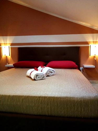a bedroom with a large bed with two pillows at Risorgimento in Avezzano