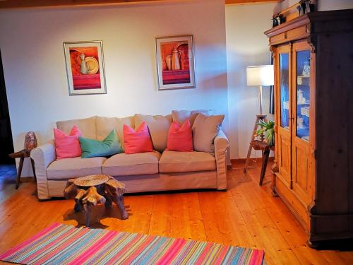 a living room with a couch with colorful pillows at Villa Grenzenlos in Löffingen