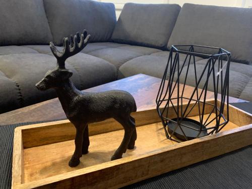 a statue of a reindeer on a coffee table at Harzstübl25 in Sankt Andreasberg
