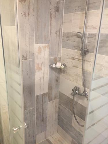 a shower with a glass door in a bathroom at Helios Hotel in Balchik
