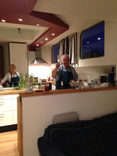 a man standing behind a counter in a kitchen at La Valse Lente in Namur