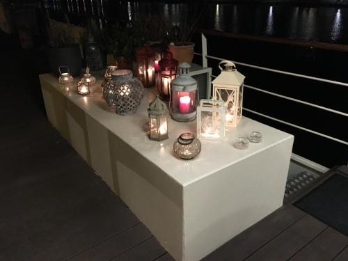 a table with candles and vases and lanterns on it at La Valse Lente in Namur