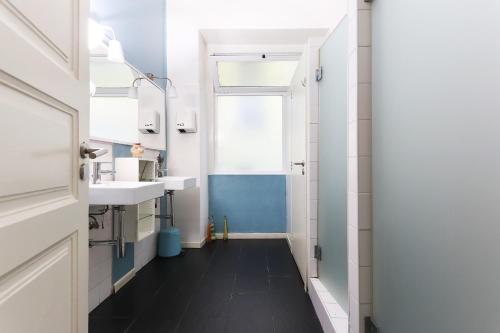 a bathroom with two sinks and a mirror at Lisbon Garden Flower in Lisbon