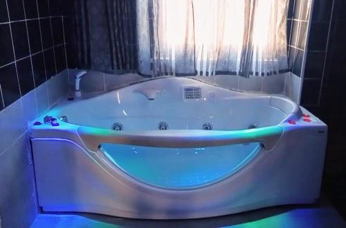 a white bath tub in a bathroom with a window at Hotel Napoleon-Cuore in Qualiano
