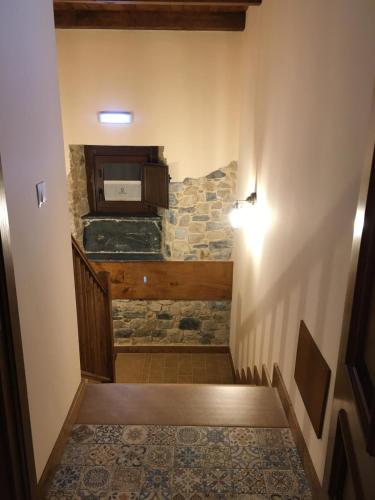 a room with a stone wall and a stairway at La Casa Vieja de Caneo - APARTAMENTOS RURALES 3 llaves in Luarca