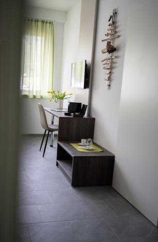 a room with a desk and a table with a laptop at eee Hotel Liezen in Liezen