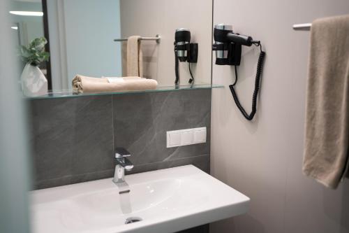 a bathroom with a sink and a mirror at eee Hotel Liezen in Liezen