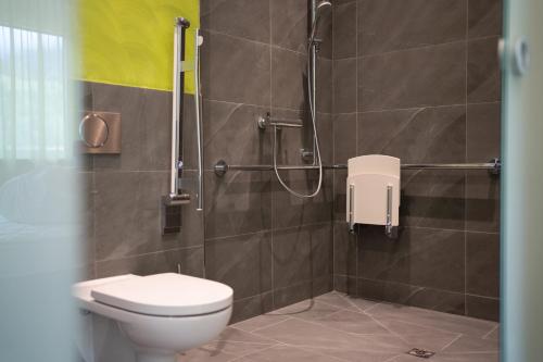 a bathroom with a toilet and a shower at eee Hotel Liezen in Liezen
