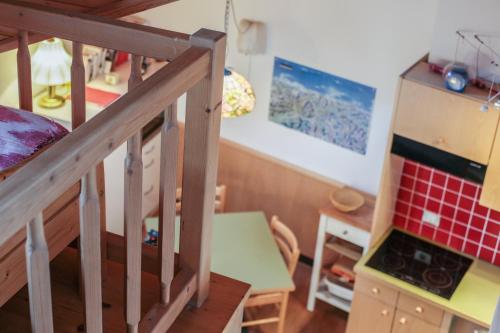 a room with a staircase and a table and a kitchen at Maisonette Meraner Blick in Avelengo
