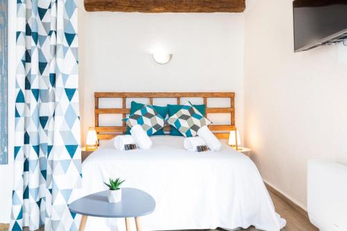 a bedroom with a bed with a blue and white patterned curtain at Résidence Le Suquet in Cannes
