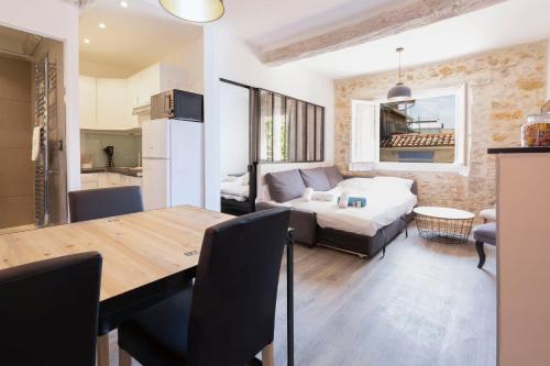 une cuisine et un salon avec une table et un canapé dans l'établissement Chez Dominique - 2 chbres 2-6pers centre Antibes Migrainier T3 with AC, à Antibes