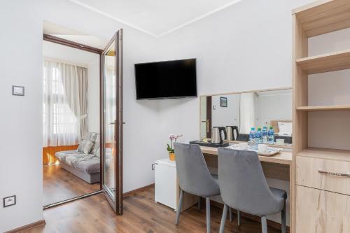 a kitchen with a table and chairs in a room at Villa Baltic Dream in Międzyzdroje