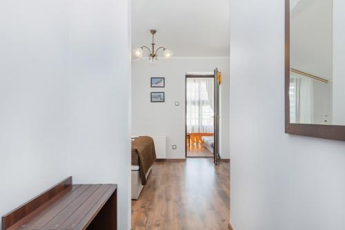 a living room with a table and a mirror at Villa Baltic Dream in Międzyzdroje