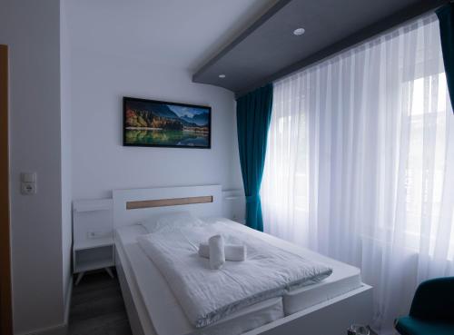 מיטה או מיטות בחדר ב-Heidepension Bispingen