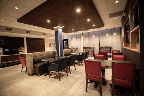 a dining room with tables and chairs in a restaurant at Holiday Inn Express & Suites - Boston South - Randolph by IHG in Randolph