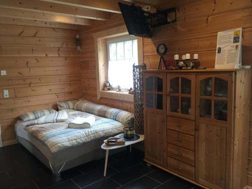 a living room with a couch and a window at Ferienwohnung Grünebach in Grünebach