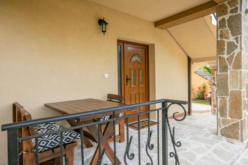 a porch with a table and chairs on a balcony at Ethno Lodge AB in Virpazar