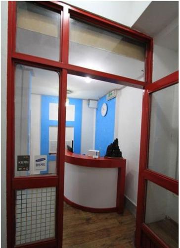 a room with a red door and a counter in a building at Yusun Guesthouse in Busan