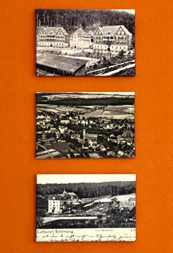 three pictures of a city on a wall at Haus am Kurpark in Schömberg