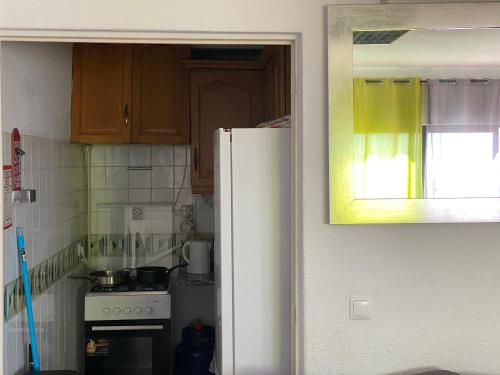 a kitchen with a white refrigerator and a stove at Algarve Vacations Flat in Albufeira