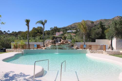 a swimming pool with a waterfall in a resort at Hotel La Torre in Tarifa