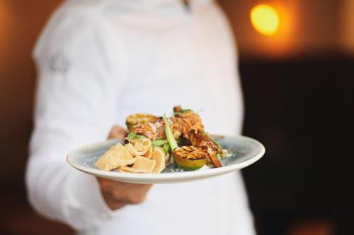 a person is holding a plate of food at Villa-Hotel De Kroon Gennep in Gennep