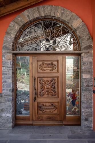 a large wooden door in a brick wall at Wine-Farm La Source in Saint-Pierre