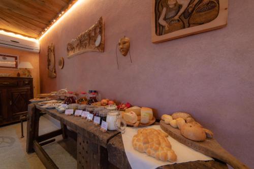 a table with different types of bread and other foods at Wine-Farm La Source in Saint-Pierre