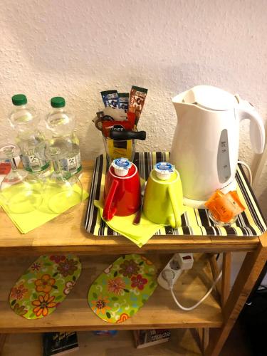 a table with a tea kettle and plates on it at Haus am Kurpark in Schömberg