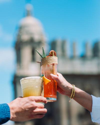 two people holding two drinks in their hands at Molina Lario in Málaga