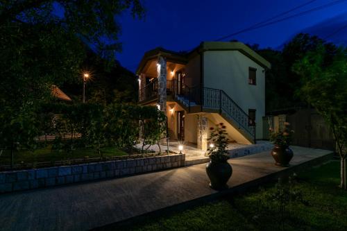 a house at night with lights at Ethno Lodge AB in Virpazar