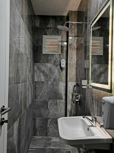 a bathroom with a sink and a mirror at Star Hotel in Oludeniz