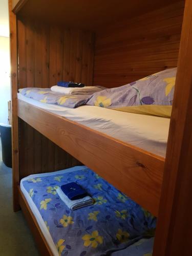 a pair of bunk beds with a cell phone on top at Ferienwohnung Abendsünn in Nordstrand