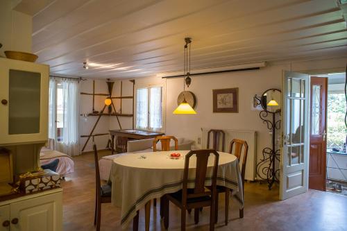 a room with a table with chairs and a kitchen at Lefkada Town Traditional House / Cozy Yard in Lefkada Town