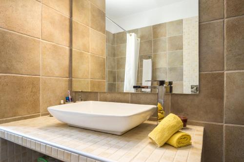 a bathroom with a large white tub on a counter at Villa Kallisti in Meganisi