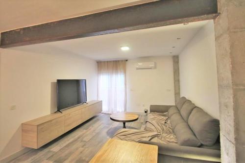 a living room with a couch and a flat screen tv at FH ALTEA CENTRO PLAYA in Altea