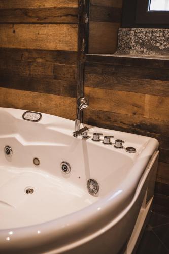 a white sink in a bathroom with wooden walls at Appartamenti montemezzo le case in pietra Vista lago in Gera Lario