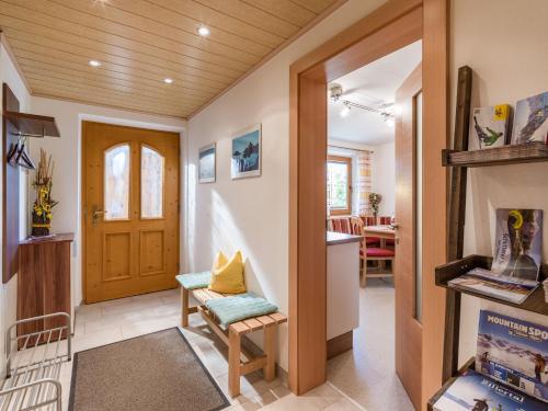 a hallway of a home with a door and a chair at Ferienwohnung Petra in Bruck am Ziller