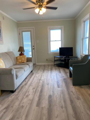 a living room with a couch and a television at Rio Motel and Suites Wildwood Beach & Boardwalk in Wildwood