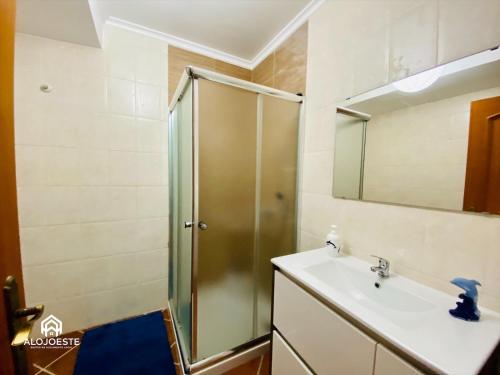 a bathroom with a shower and a sink at Garden Park III in Ericeira