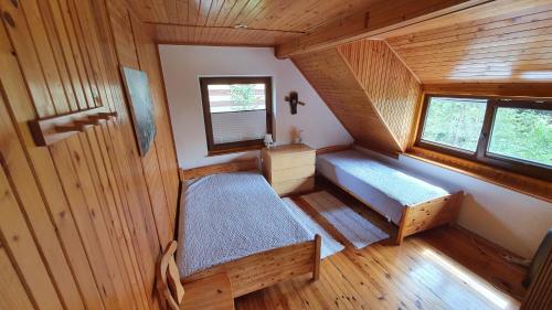 a small room with two beds and a window at Domek Eve in Giżycko