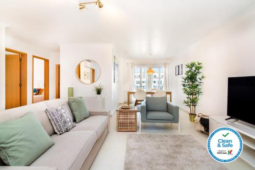 a living room with a couch and a tv at LXLUXHOME - Casino Premium Apartment in Lisbon