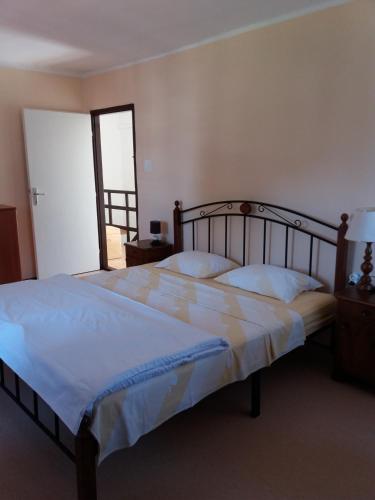 a bedroom with a large bed with white sheets at House Mergi 2 in Pomer