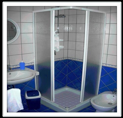 a bathroom with a shower and a sink and a toilet at Agriturismo Nakelia in Zambrone
