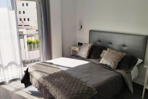 A bed or beds in a room at Apartamentos Gran Plaza De Nerja