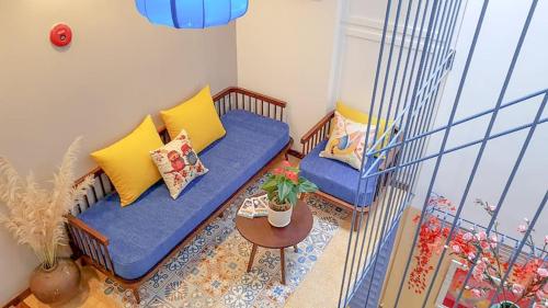 a living room with a blue couch and a table at Son Trang Hotel Hoi An in Hoi An