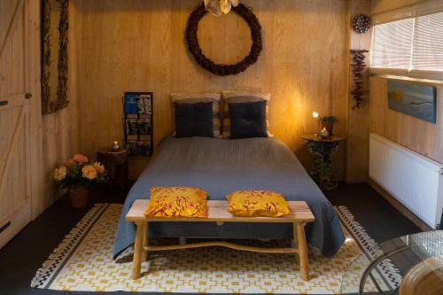 Un dormitorio con una cama y una mesa. en Tuinhuis en Lutjewinkel