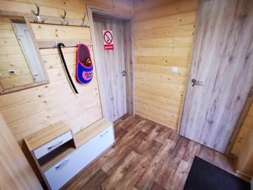 a small room with a surfboard on the wall at Chata BAŠKA na Liptove s vlastným dvorom in Liptovský Mikuláš